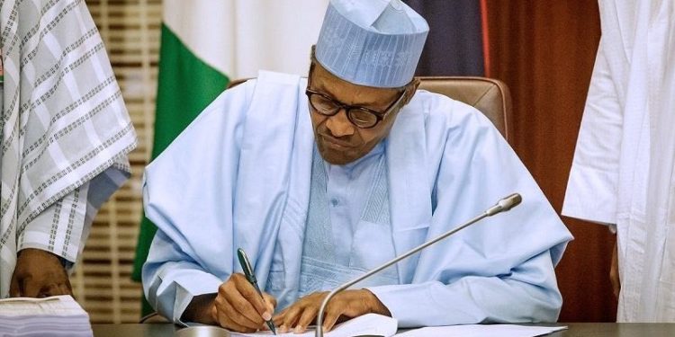 President Muhammadu Buhari signing the bill