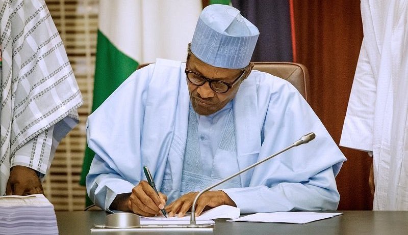 President Muhammadu Buhari signing the bill