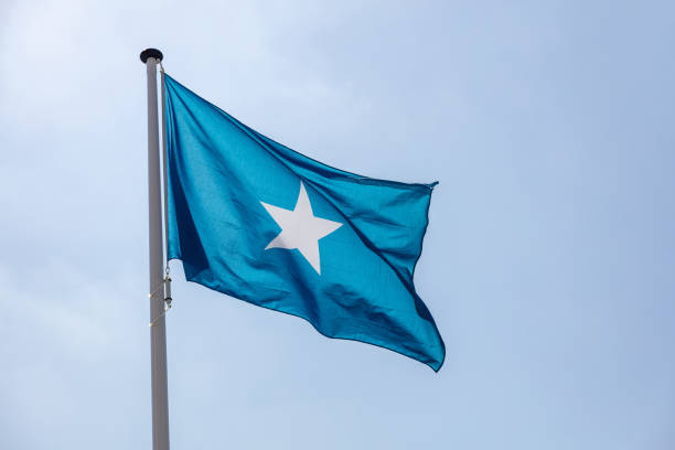 Somalia flag, National symbol waving against clear blue sky, sunny day