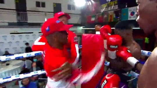 A boxing match in South Africa descended into chaos when a trainer attacked a fighter